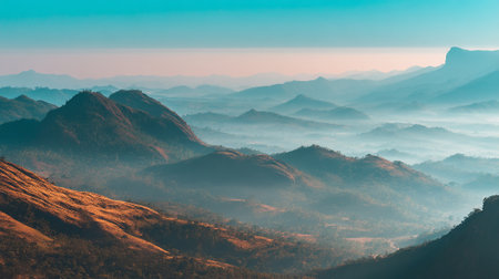 Misty Mountain Landscape with Rolling Hills and Vibrant Sky Horizonの素材