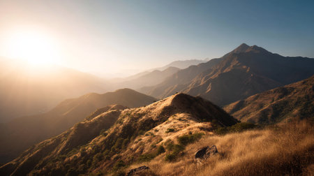 Golden Sunlight Shines Over Layered Mountain Peaks in a Serene Landscapeの素材