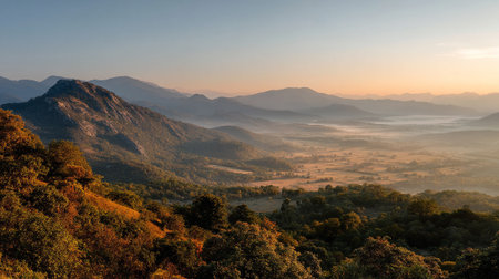 Majestic mountain landscape at dawn with valley fog and golden sunlightの素材
