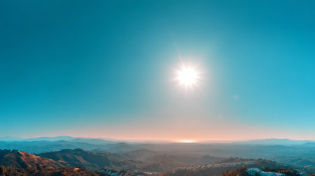Scenic Vista with Sunburst over Distant Mountains and Urban Landscapeの素材