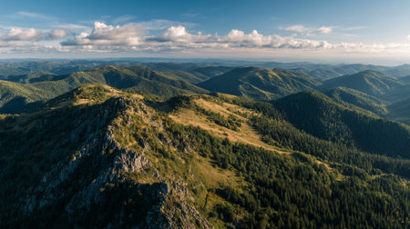 Stunning Aerial View of Green Mountain Ranges and a Partially Cloudy Skyの素材