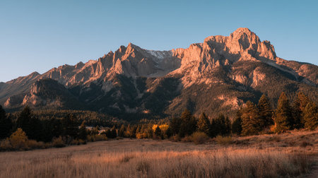 Majestic Mountain Range Bathed in Warm Sunlight Glow at Golden Hourの素材