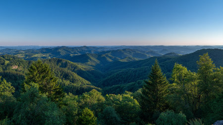 Verdant Mountain Range Panorama Under Clear Blue Sky Offers a Tranquil Vistaの素材