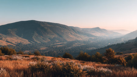 Expansive Mountain Vista Landscape with Rolling Hills and Golden Grasses at Sunriseの素材
