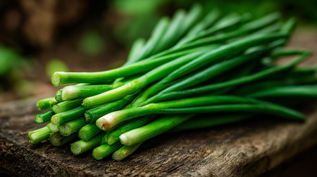 Fresh Organic Green Onions: A Vibrant Bunch on Weathered Wood Surfaceの素材