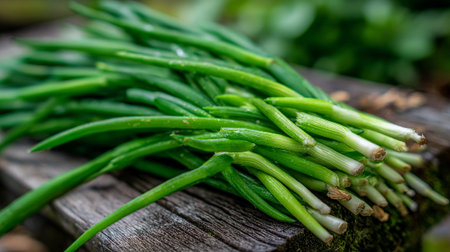 Fresh Green Onions: A Vibrant Harvest Displayed on Rustic Wood Surfaceの素材