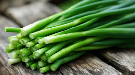 Freshly Harvested Green Onions Displayed on Weathered Wood Surface For Culinary Useの素材