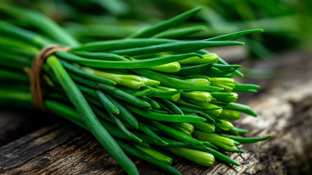 Fresh Bunch of Green Chives Tied with Twine Resting on Woodの素材