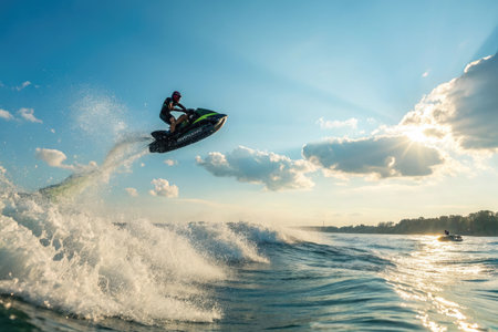 Professional jet ski rider in action at sunset. Extreme water sport.の素材