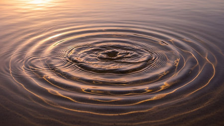 Water drop on the surface of the water with waves and ripplesの素材