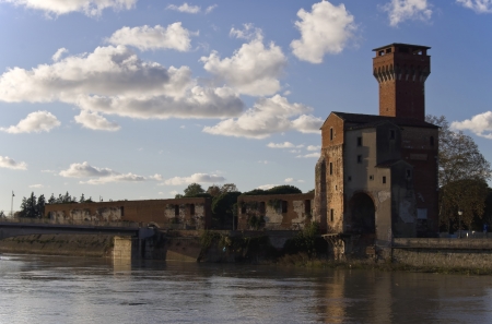 Ghibelline tower on river Arno bank in Pisa - Italyの写真素材