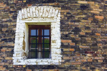 window of a windmill built of colorfull bricksの写真素材