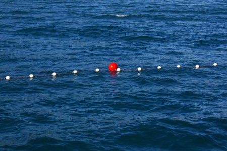 Red buoy in a rope in the blue sea
の写真素材