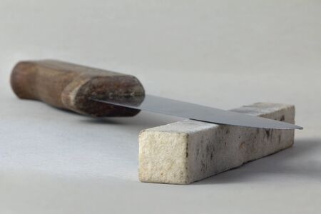 Kitchen knife and honing stone, shallow depth of fieldの写真素材