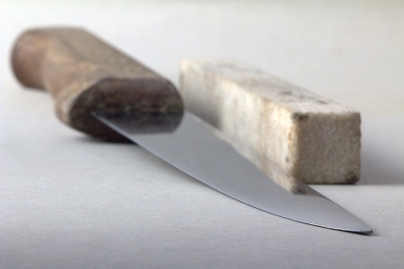 Kitchen knife and honing stone, shallow depth of fieldの写真素材