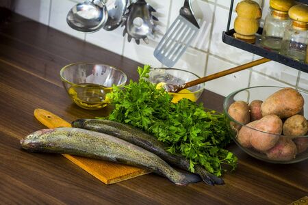 Two raw trouts on the kitchen table, ready to cookの写真素材