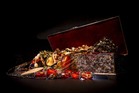 Silver treasure box in the dark, full of necklaces and jeweleryの写真素材