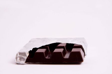 Chocolote in sealed silver paper on isolated white background.の写真素材