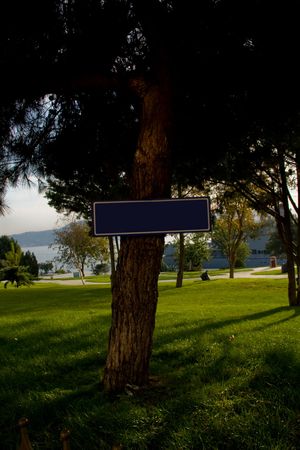 Sign at park. Nailed on tree...の写真素材