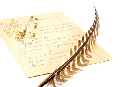 the quill and the paper sheet full of notes isolated on white backgroundの写真素材