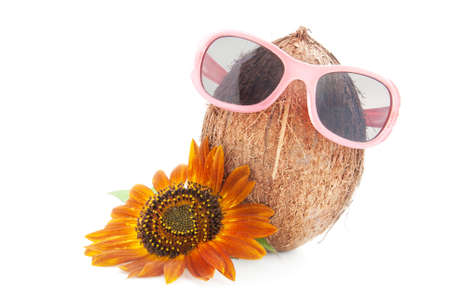 coconut with sunflower in a sunglasses isolated on white background conceptの写真素材