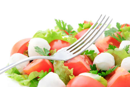 fresh vegetable salad with tomatos, cheese mozzarella and greensの写真素材