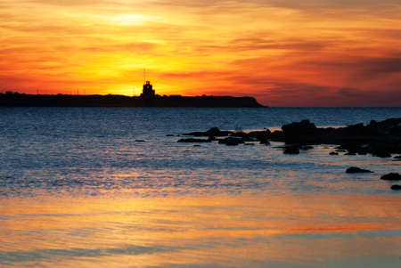 Bright sunset under the sea surface with yellow orange and red colorsの写真素材