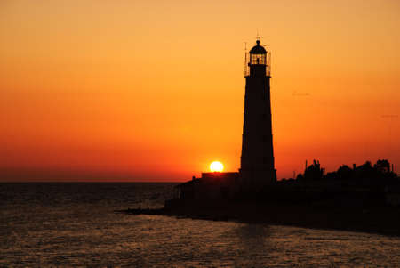 Bright beautiful sea sunset panorama above the beacon towerの写真素材