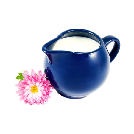 milk jug with milk and flowerの写真素材