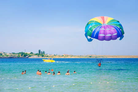 colorful paragliding in the clear sky above the seaの写真素材