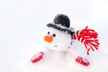 happy winter toy christmas snowman with carrot in black hat and red mittensの写真素材