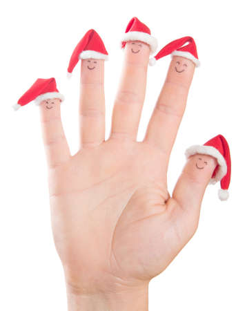 Fingers faces in Santa hats isolated on white background. Happy family celebrating concept for Christmas day.の写真素材