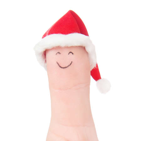 Finger funny face in Santa hat. Concept for Christmas day. Isolated on whiteの写真素材