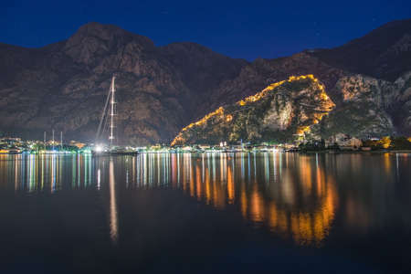 Night view of Kotor Fortress wall up to Lovcen Mountain with heart-shape reflection in water. Montenegro, Kotor Bay (Boka Kotorska)の写真素材