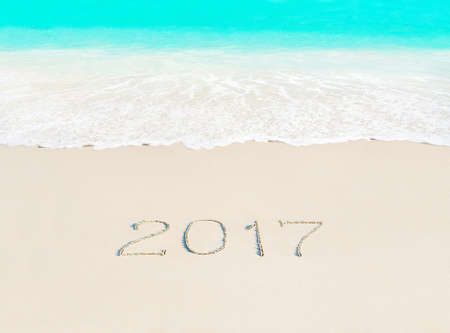 Happy New Year 2017 travel season concept on azure tropical sandy beach - winter vacation in hot countries backgroundの写真素材