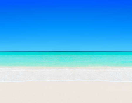 Idyllic perfect tropical white sandy beach and turquoise clear ocean water - summer vacation natural background with blue sunny skyの写真素材