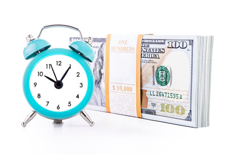 Ten thousand united states dollars currency banknotes bundle and green clock isolated on white...