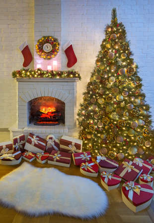 Cozy New Year home room interior with fir tree, fireplace, Christmas stocking, wreath with clock, garlands, gifts heap and woolen carpet preparing for holidays celebrationの写真素材