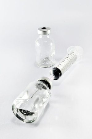 medical ampoules and syringe isolated on white