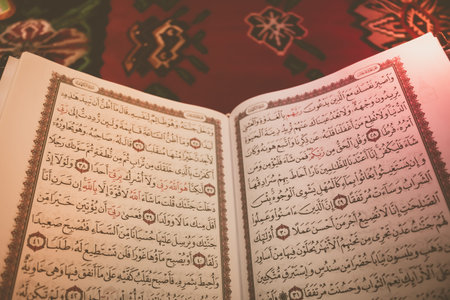 Holy book of Muslims around the world. An open page of Quran