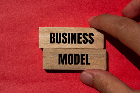 Business model message written on wooden blocks with red background. Conceptual business model...