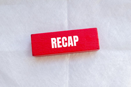 Recap word written on red wodoen block with white background. Conceptual recap word symbol.の写真素材