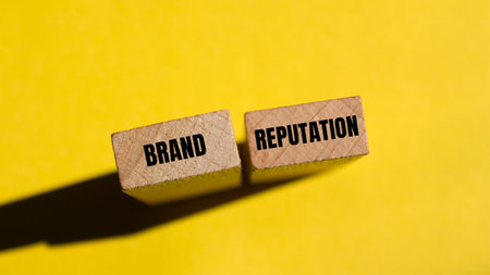 Brand reputation message written on wooden blocks with yellow background. Conceptual brand reputation symbol. Copy space.の写真素材