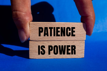 Patience is power message written on wooden blocks with blue background. Conceptual patience is a symbol of power. Copy space.の写真素材