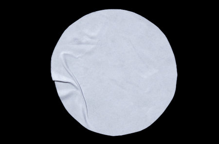 White adhesive glued round paper sticker label isolated on black background