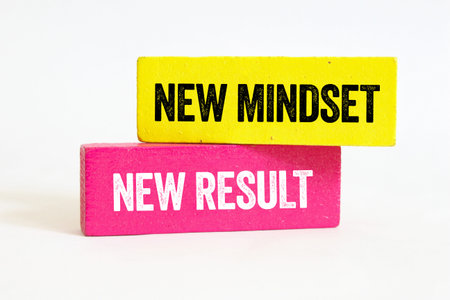 New mindset new result message written on wooden blocks on white background. Conceptual new mindset new result symbol. Copy space.の写真素材