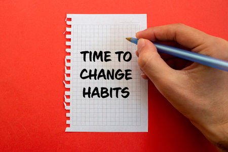 Time to change habits message written on white paper on red background. Conceptual time to change habits symbol. Copy space.の写真素材