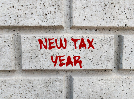 New tax year message written on gray stone wall. Conceptual new tax year symbol. Copy space.の写真素材