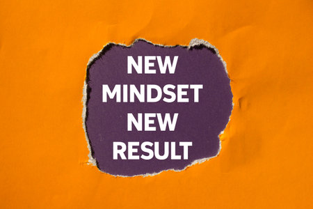 New mindset new result message written on ripped torn orange paper on purple background. Conceptual new mindset new result symbol. Copy space.の写真素材