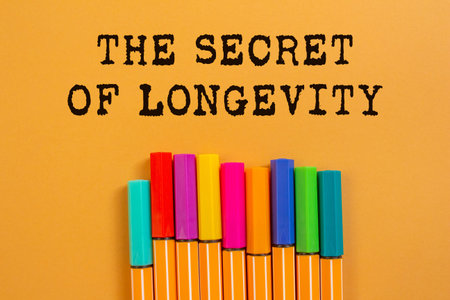 The secret of longevity message written on orange background. Conceptual the secret of longevity...